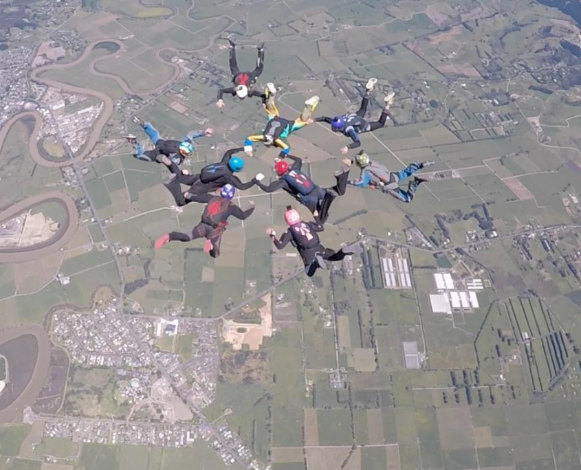 Skydivers tracking in the clouds
